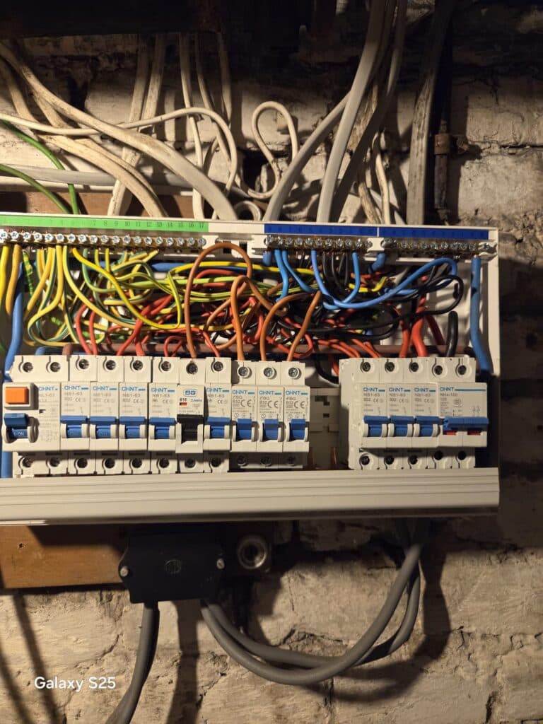 Consumer unit wiring inspected during failed EICR remedial works in Wimbledon showing circuit breakers and electrical connections