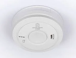 White Aico smoke alarm mounted on ceiling in London rental property installed by landlord electrician for EICR and electrical safety compliance