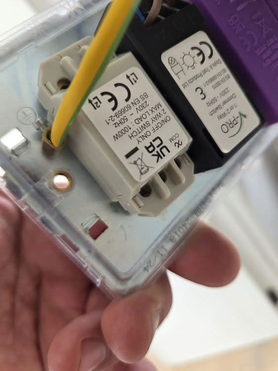 Replacing a faulty dimmer module during electrical repairs in Morden by BuildSpark